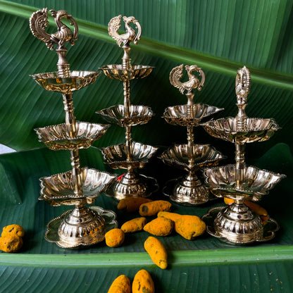 Set of silver metal lamps with decorative top on a green leaf background